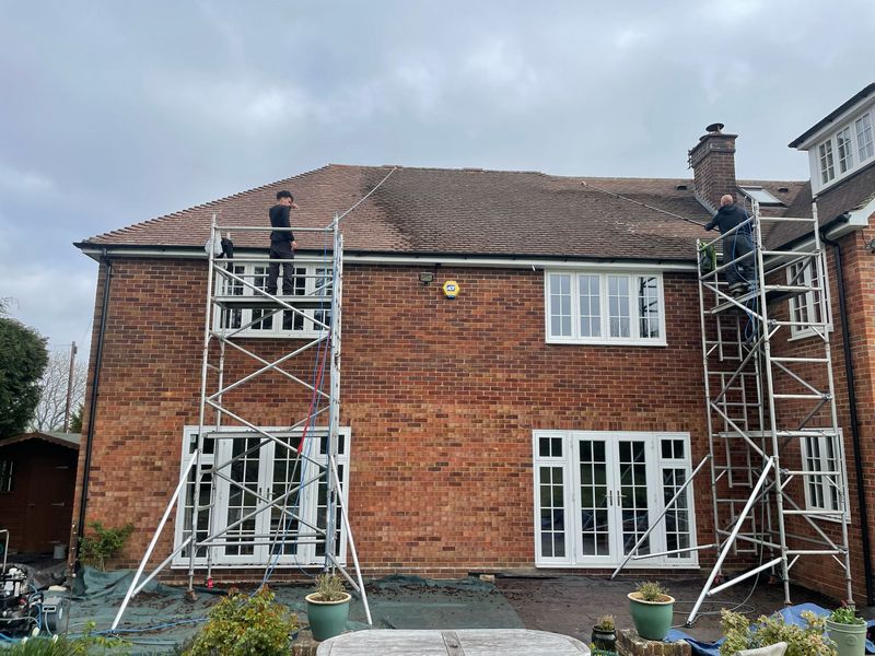 Roof cleaning carried out safely from scaffold towers by The Roof Moss Cleaners in Sawtry